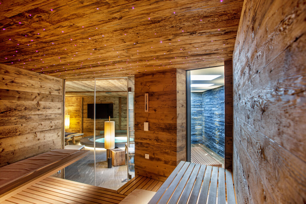 KLAFS sauna with rustic old wood and hemlock on the benches Engadiner Bauernhaus